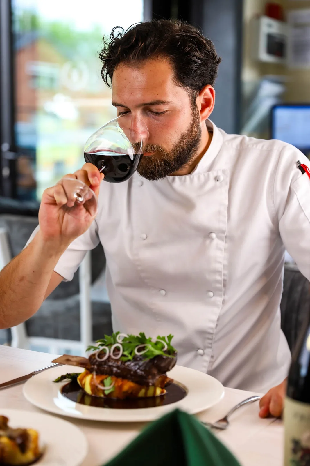 Chef Berk Önce with a glass of wine